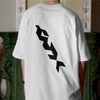 Person wearing a white t-shirt with black logo on the back, standing indoors.